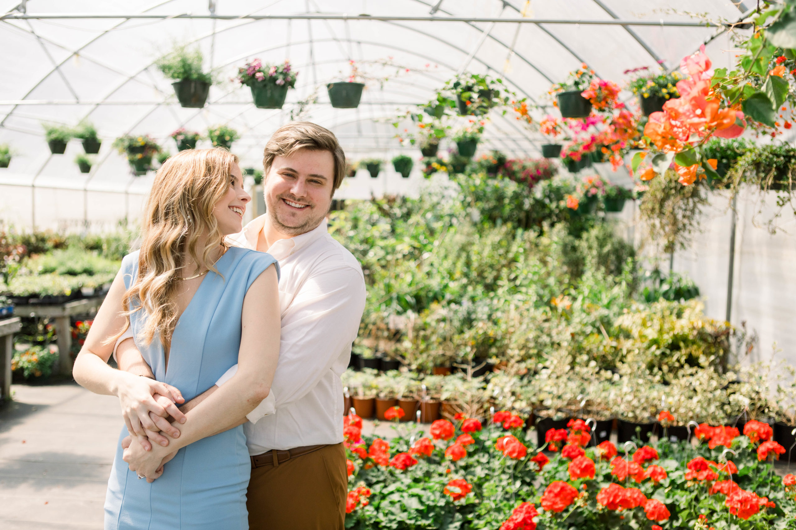 Couple posing in greenhouse Pensacola Engagement