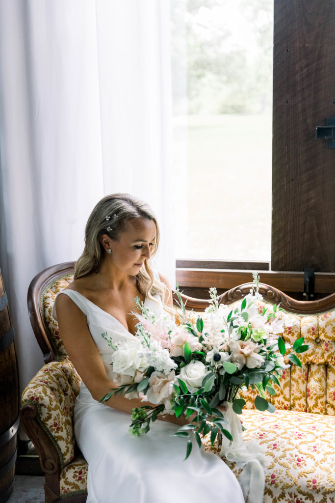 Bride sitting on a couch at Live Oak Plantation