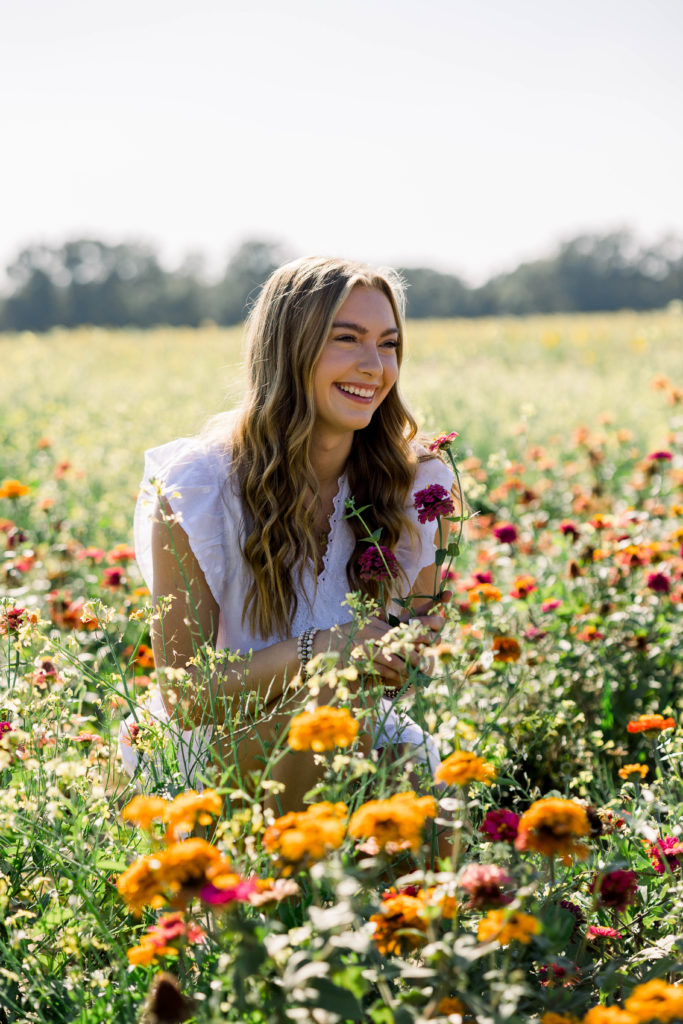 girl laughing with wildflowers around her