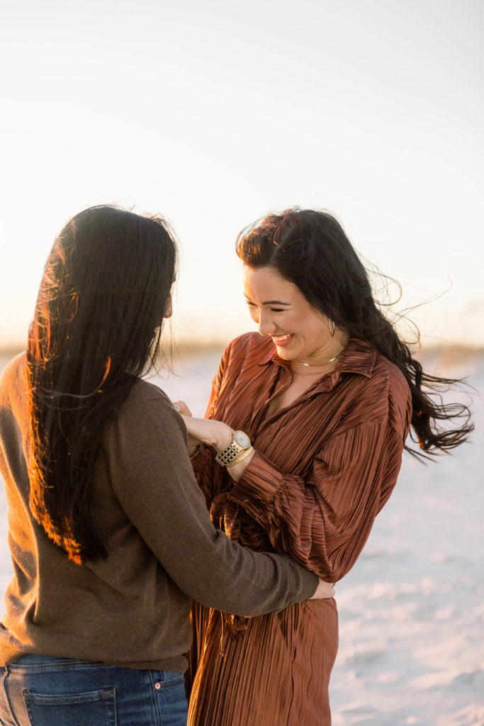 two women hugging admiring ring