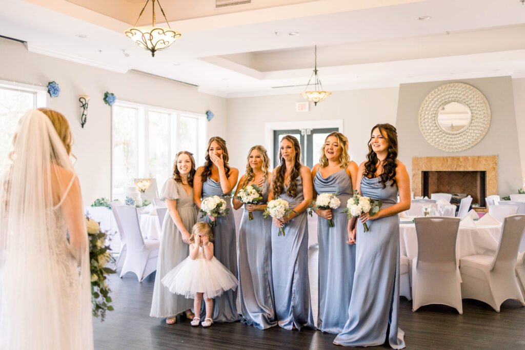 Bridesmaids looking surprised at bride for first look