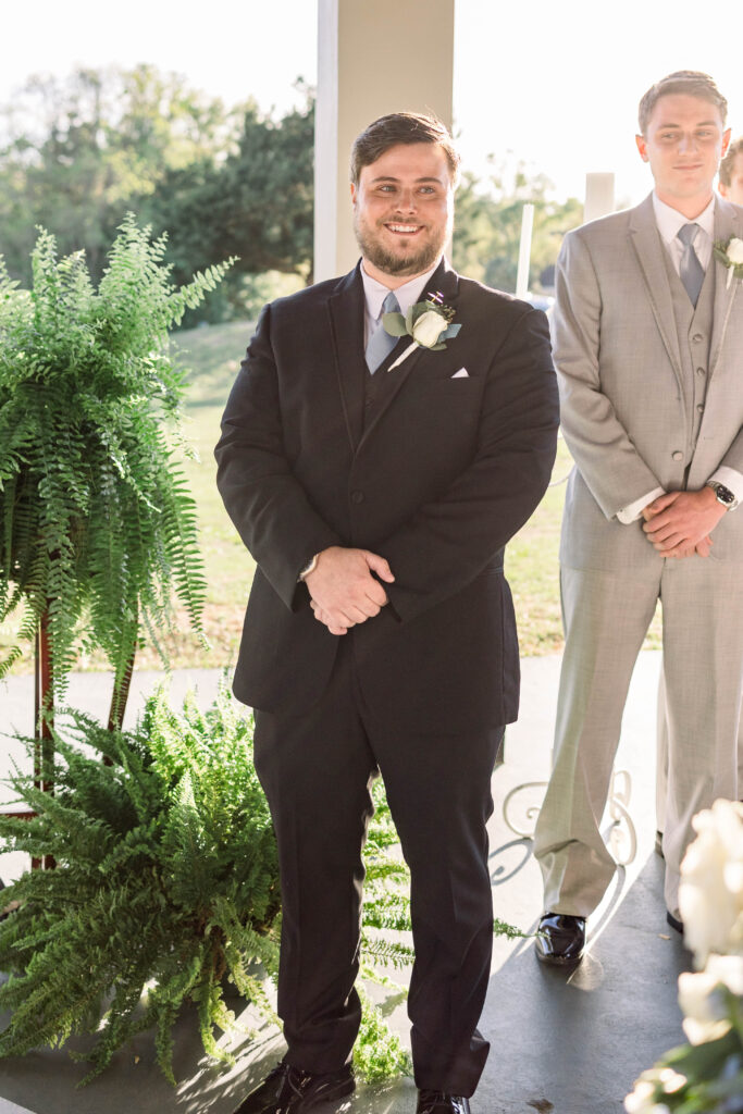 Groom seeing bride on wedding day for the first time during ceremony