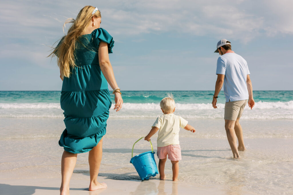 Family running toward the water on Pensacola Beach