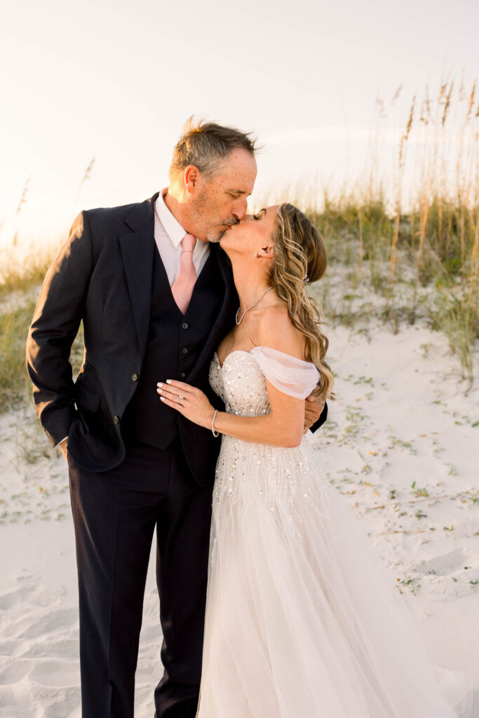 Couple posing on beach at Pier Suit Wedding on Pensacola Beach