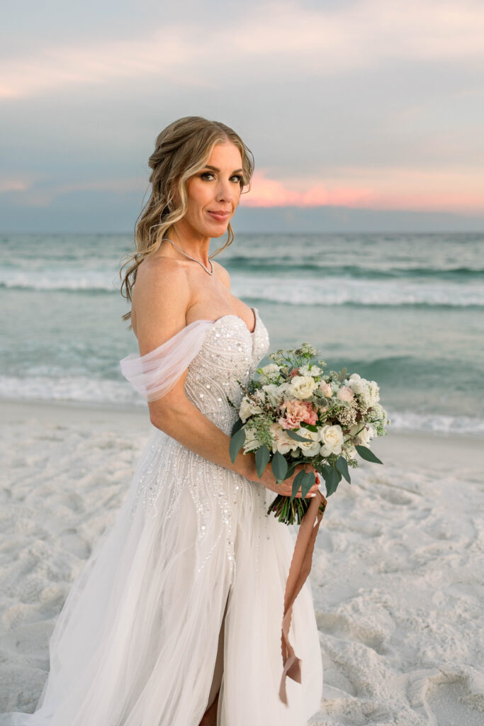 Bride posing with bouquet on Pensacola Beach