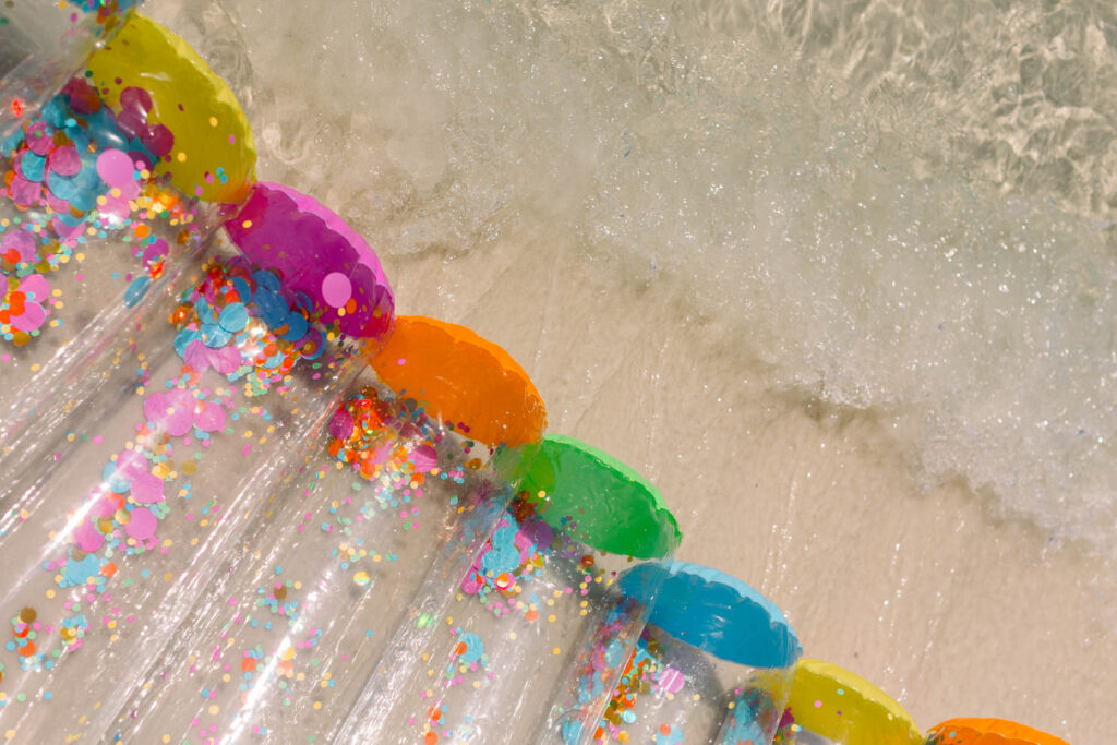 Cute confetti floatie on the water on the beach!