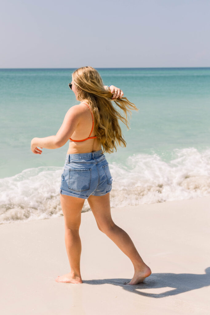 Girl walking toward water on Pensacola Beach