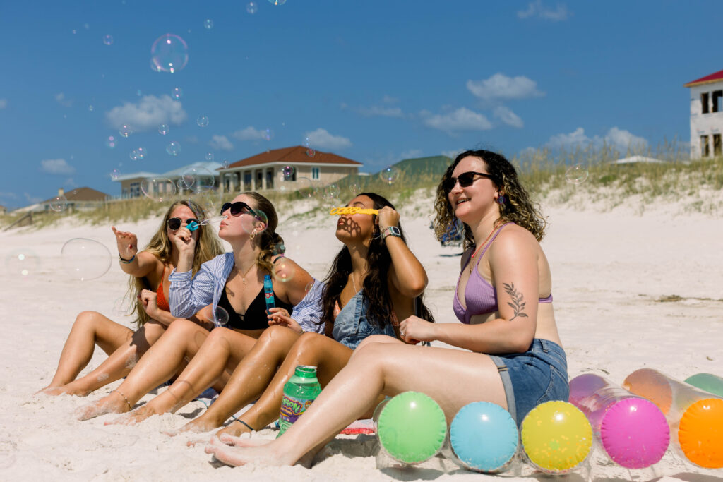 Girls blowing bubbles during a photoshoot on Pensacola Beach