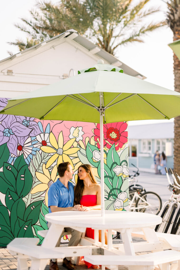 Couple kissing under an umbrella in Seaside Square Florida